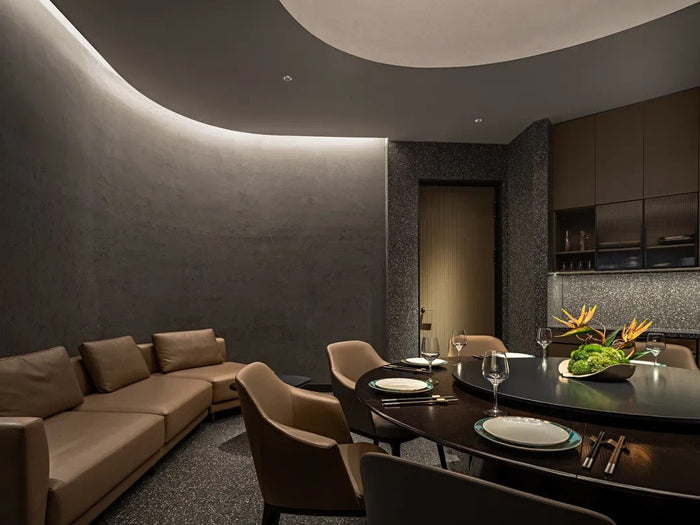 Fine-dining room with sculpted linear ceiling lighting