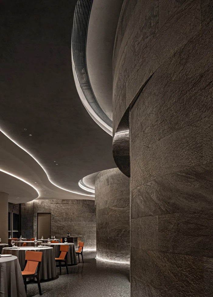 Fine-dining room with sculpted linear ceiling lighting