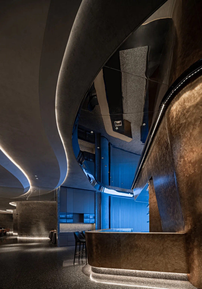 Fine-dining room with sculpted linear ceiling lighting