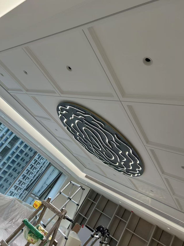Flush ovoid crystal ceiling chandelier installed in a coffered ceiling