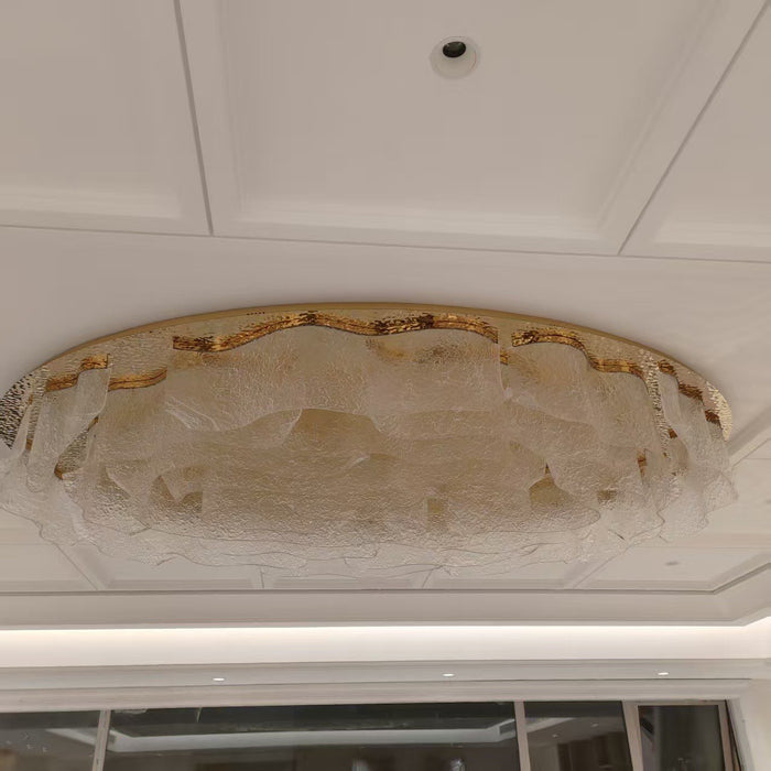 Flush ovoid crystal ceiling chandelier installed in a coffered ceiling