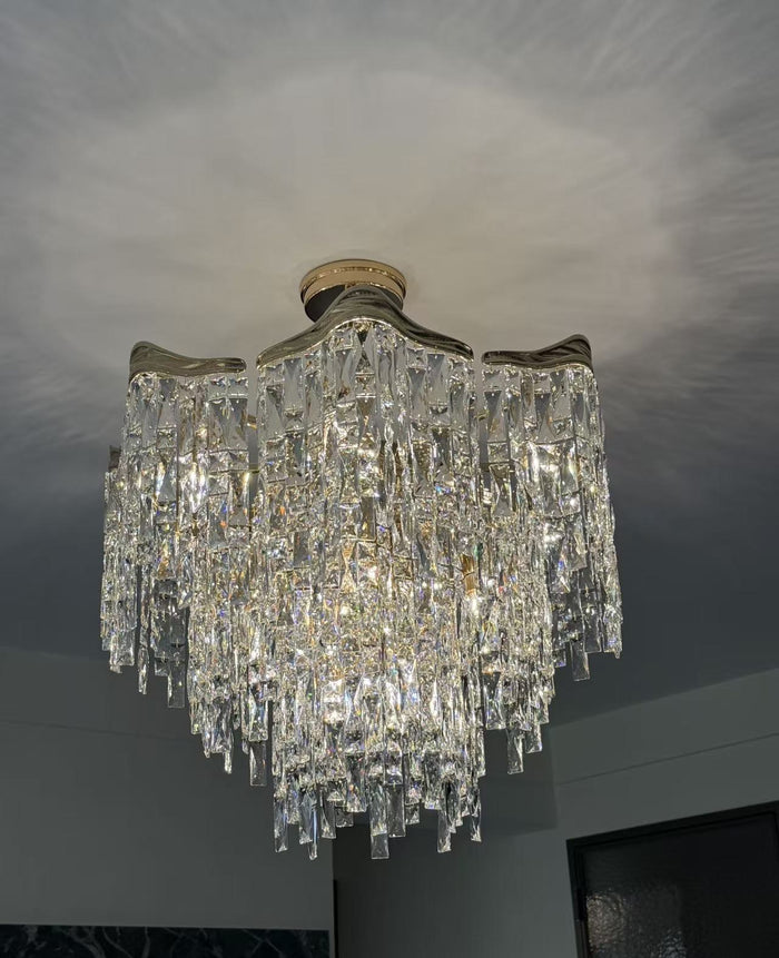 Linear crystal island chandelier over a dark kitchen island
