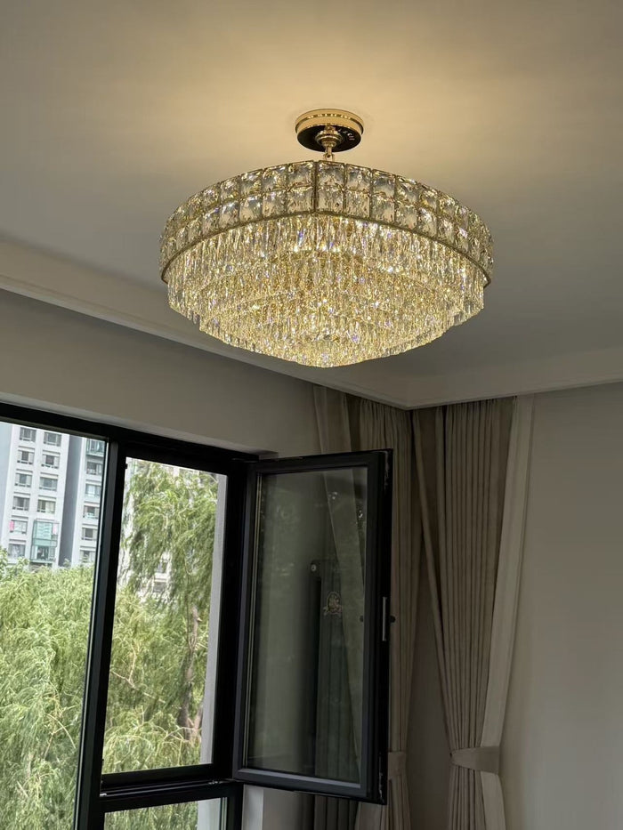 Linear crystal island chandelier over a dark kitchen island