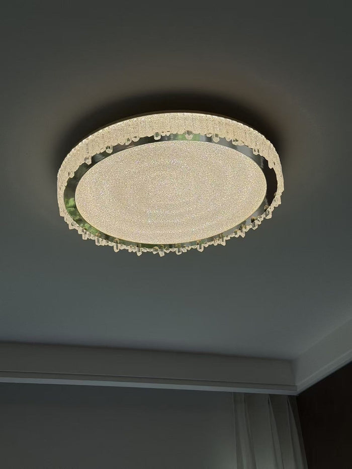 Linear crystal island chandelier over a dark kitchen island