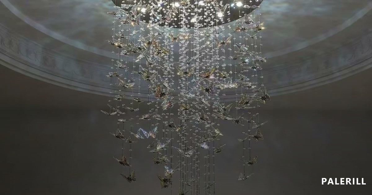 Cascading crystal butterfly chandelier suspended in a domed double-height space