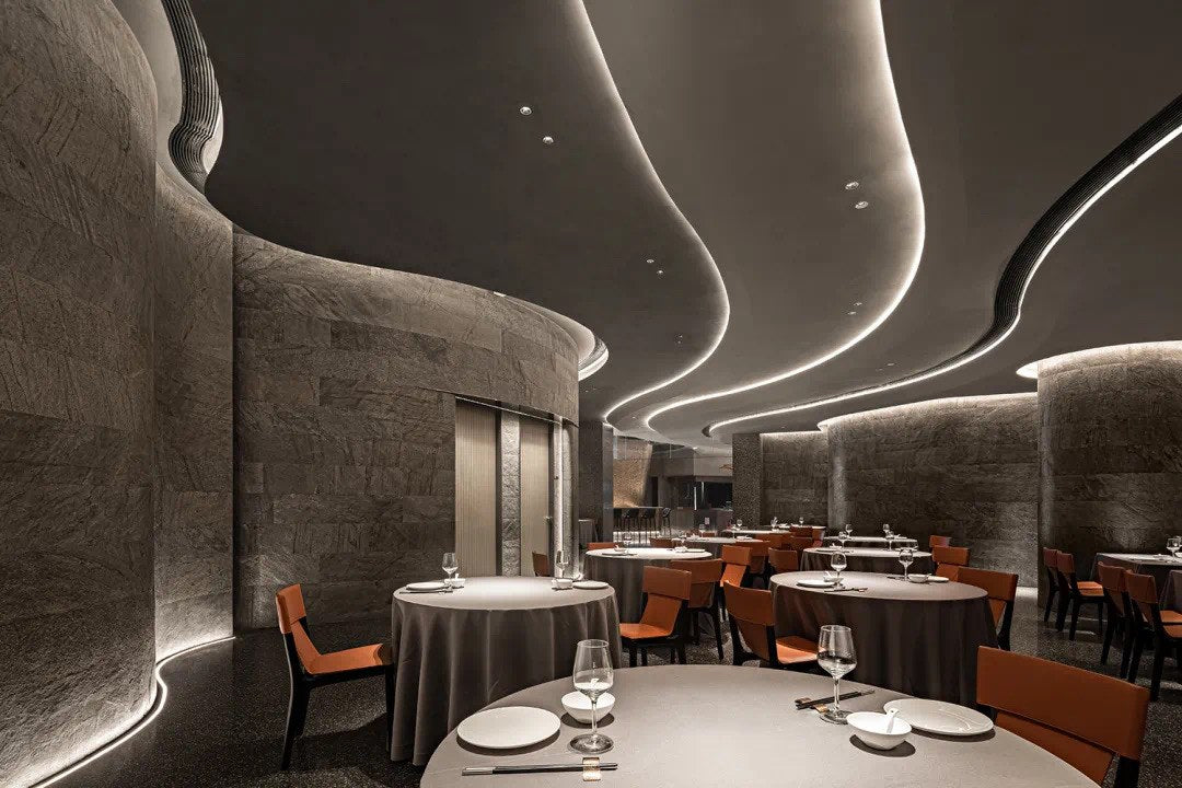 Fine-dining room with sculpted linear ceiling lighting