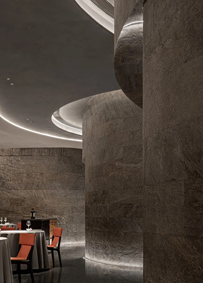 Fine-dining room with sculpted linear ceiling lighting