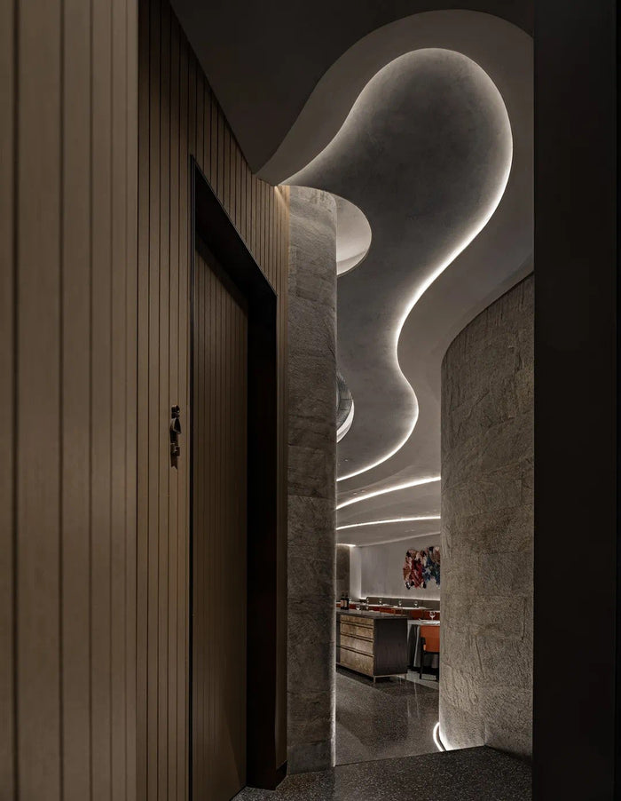 Fine-dining room with sculpted linear ceiling lighting
