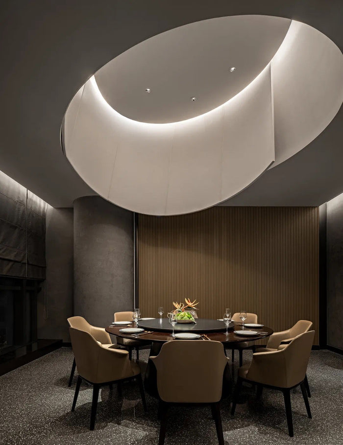 Fine-dining room with sculpted linear ceiling lighting