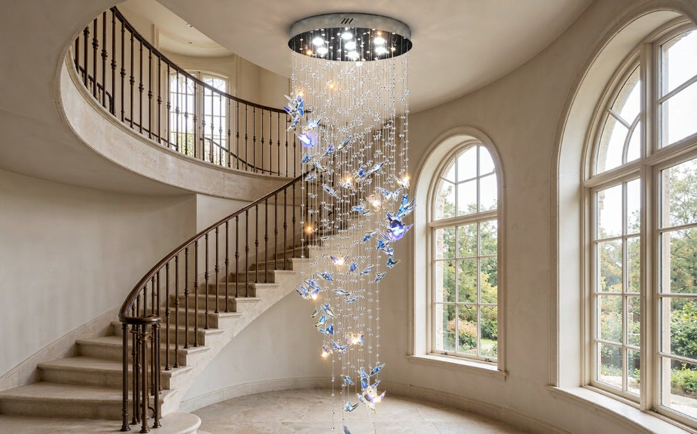 Cascading crystal chandelier with blue crystal butterflies in a double-height stairwell